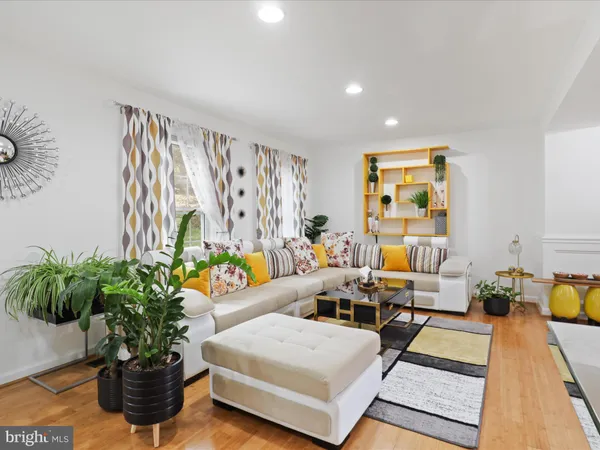 a living room with furniture and flowers