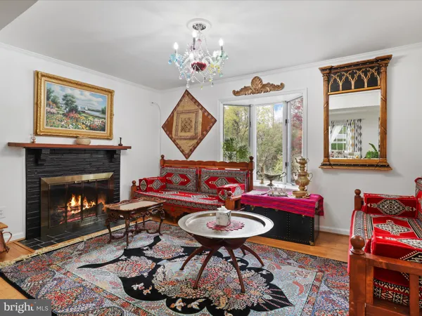 a living room with furniture a window and a fireplace