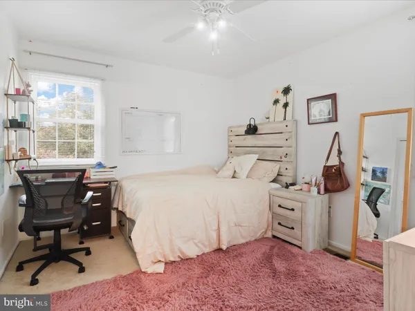 a bedroom with a bed and a chair in it