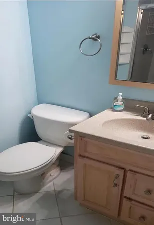 a white toilet sitting next to a bathroom sink