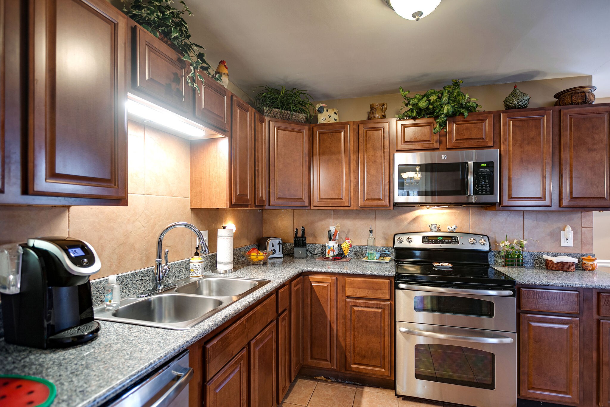 1011 General George Patton Road Nashville, TN 37221 - Photo 9 of 30 a kitchen with granite countertop a sink a stove and cabinets