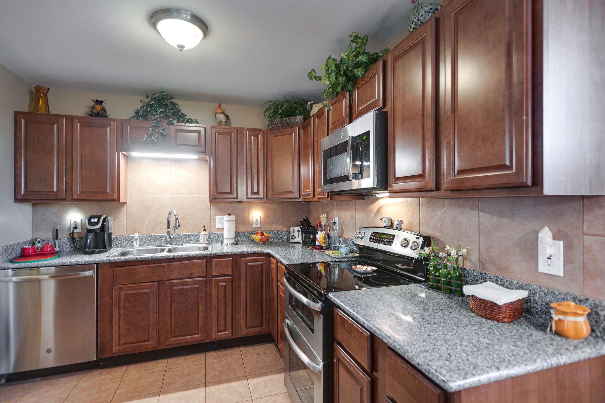 1011 General George Patton Road Nashville, TN 37221 - Photo 10 of 30 a kitchen with stainless steel appliances granite countertop a sink dishwasher stove and cabinets