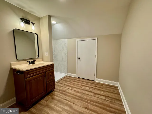 a bathroom with a sink a mirror and a vanity
