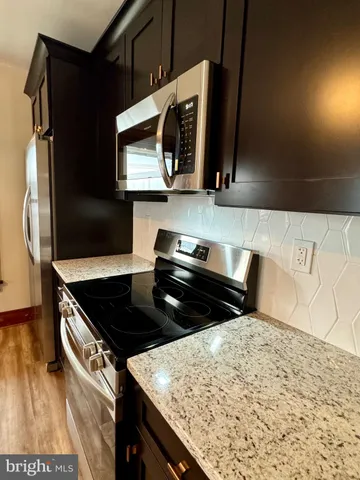 a kitchen with a stove and a microwave