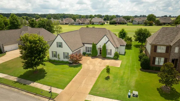 a aerial view of a house with garden and lake view