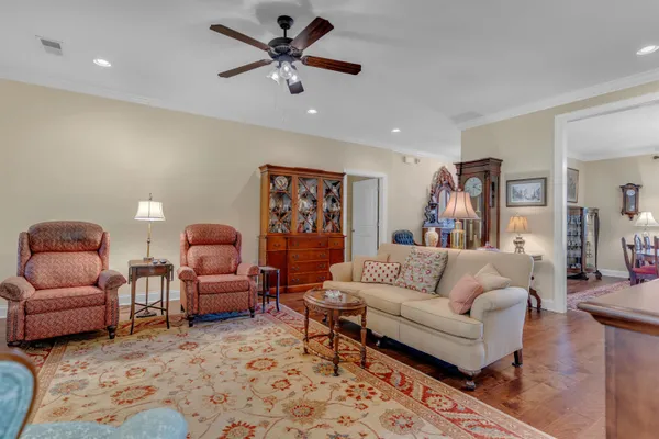 a living room with furniture a rug and a chandelier