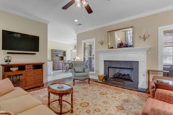 a living room with furniture a flat screen tv and a fireplace