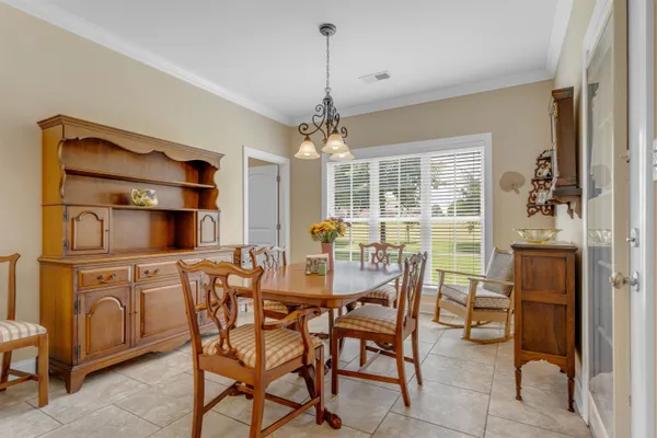 a dining room with furniture and window