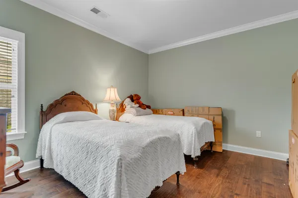 a bedroom with bed and a window