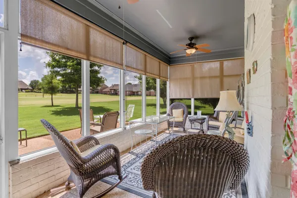 a view of a patio with table and chairs floor to ceiling window with wooden floor