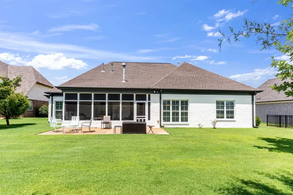 a front view of a house with a garden and yard