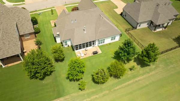 an aerial view of a house with a yard basket ball court and outdoor seating