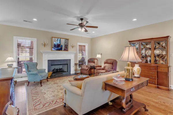 a living room with furniture a table and a fireplace