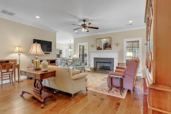 a living room with furniture fireplace and a window