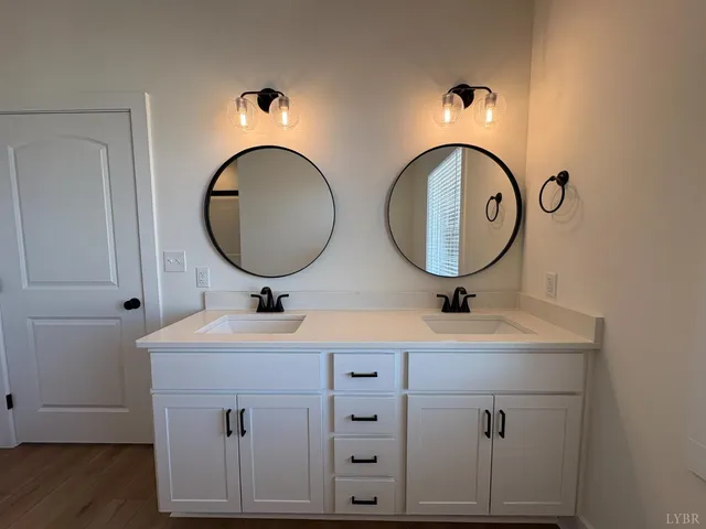 a bathroom with 2 sink and a mirror