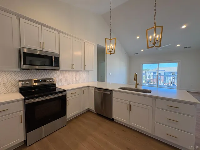 a hallway with wooden floor and stairs