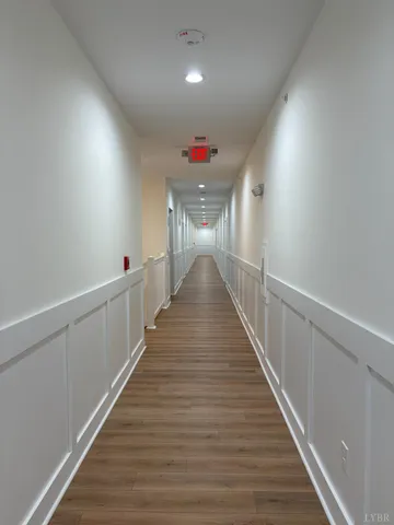 a view of a hallway with wooden floor