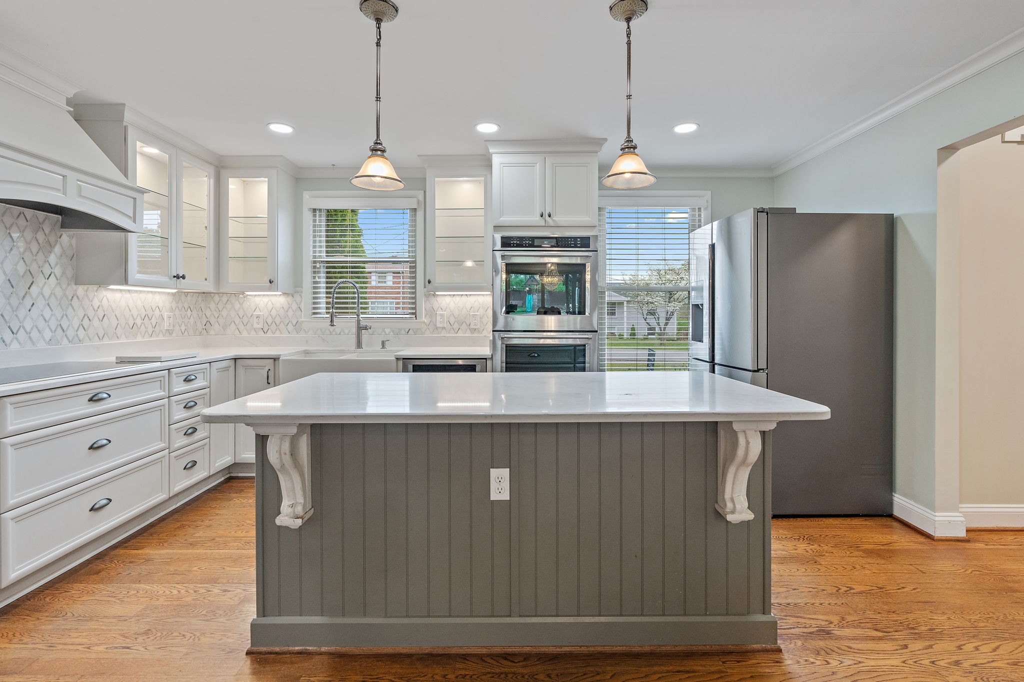 a kitchen with stainless steel appliances granite countertop a sink a refrigerator and a stove