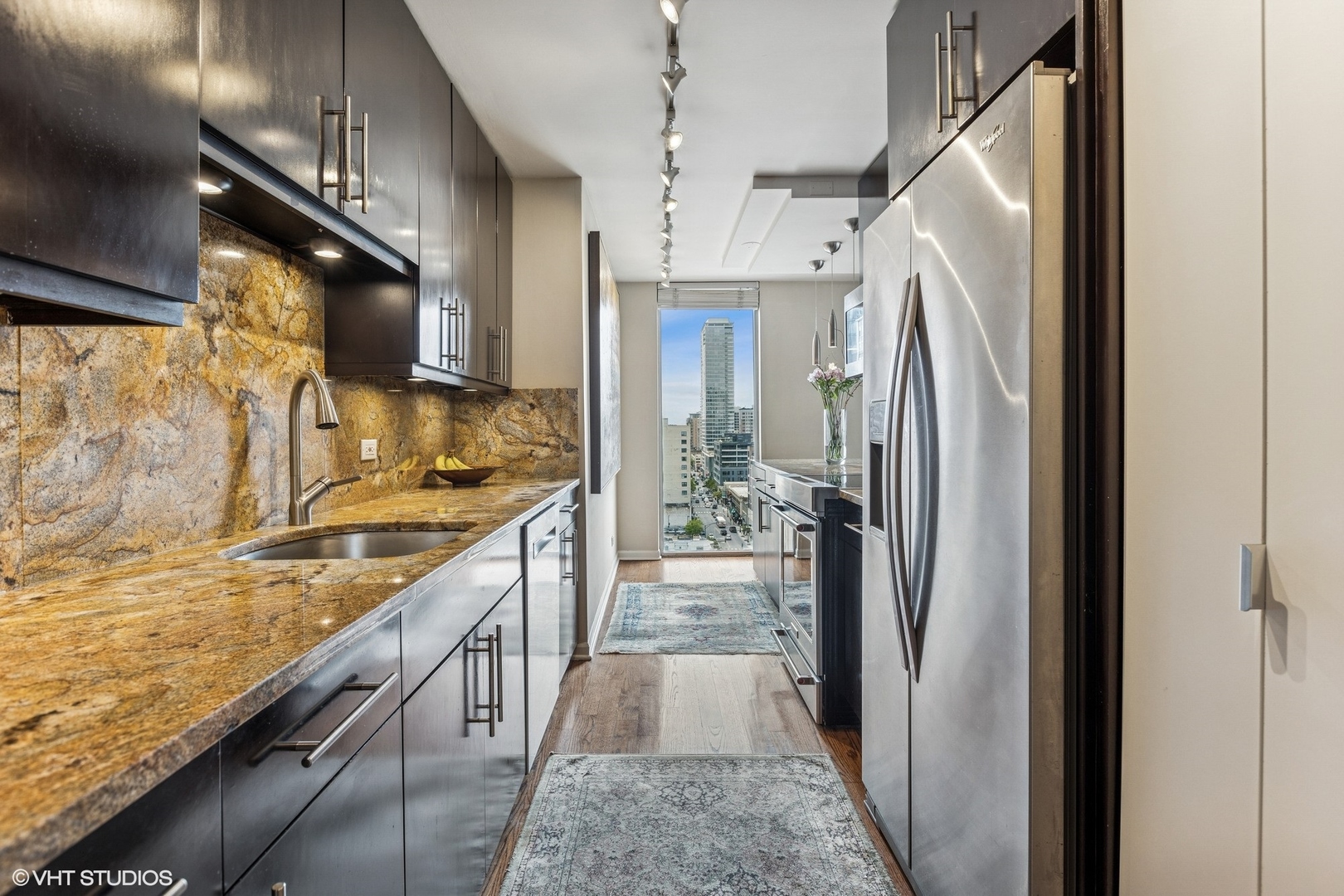 71 East Division Street, Unit 1606 Chicago, IL 60611 - Photo 15 of 34 a kitchen with stainless steel appliances granite countertop a refrigerator a oven and a sink