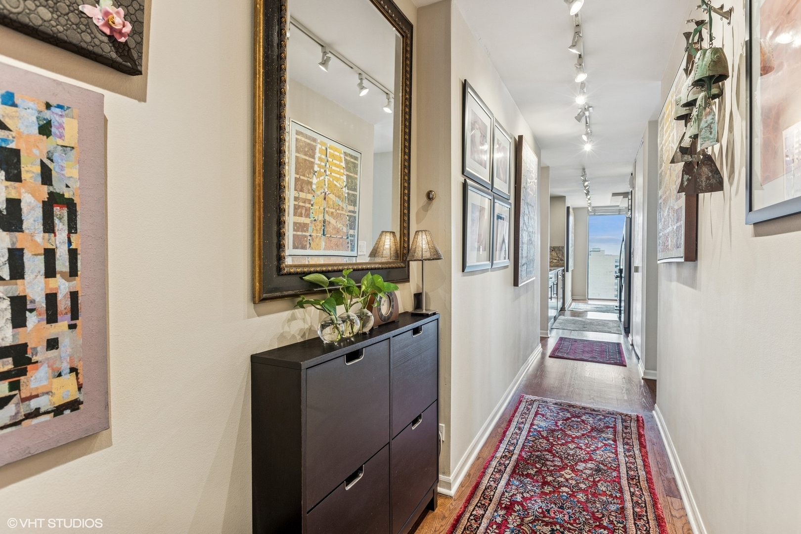71 East Division Street, Unit 1606 Chicago, IL 60611 - Photo 2 of 34 a hallway with a dining table and chairs