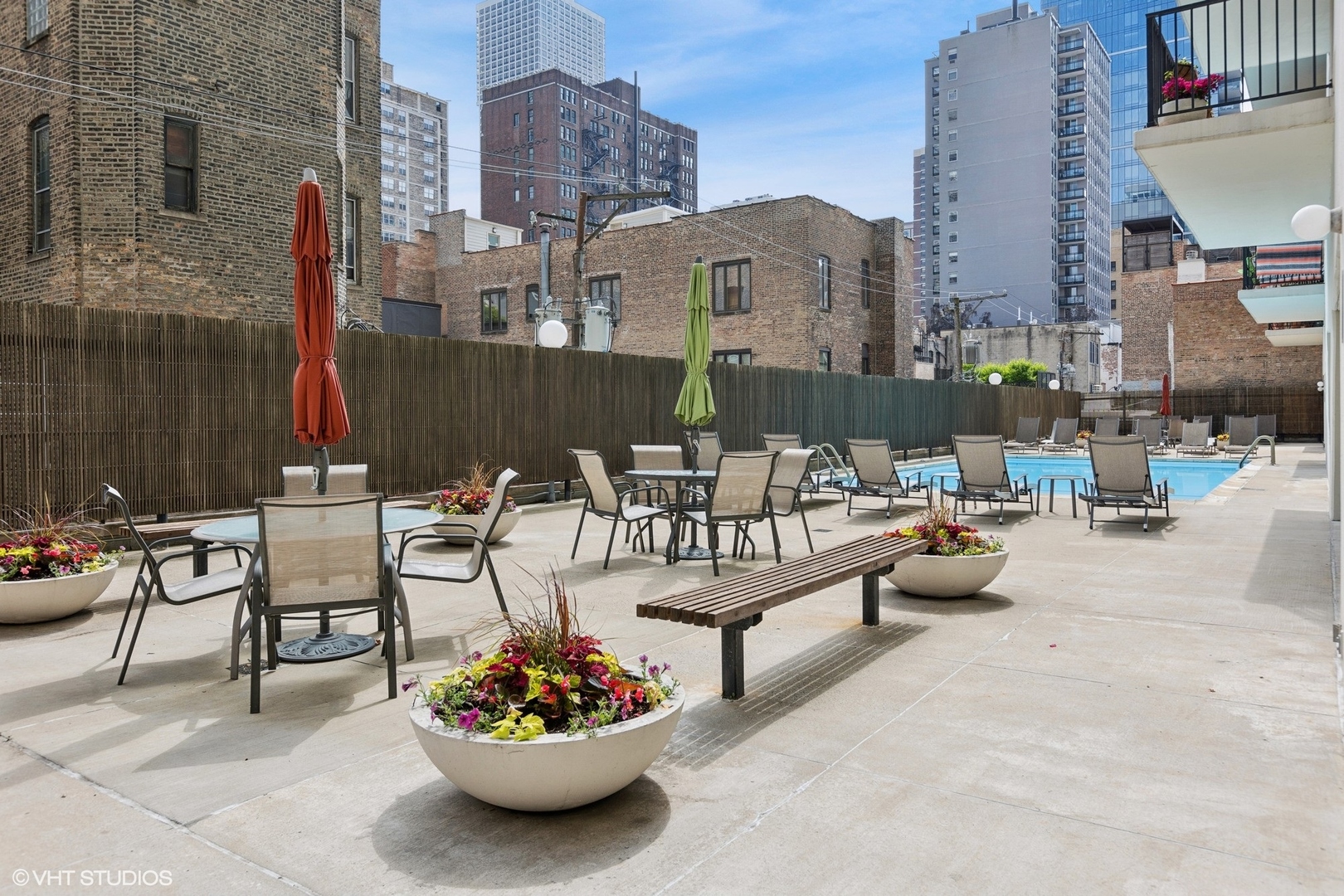 71 East Division Street, Unit 1606 Chicago, IL 60611 - Photo 26 of 34 a view of a patio with dining table and chairs and potted plants
