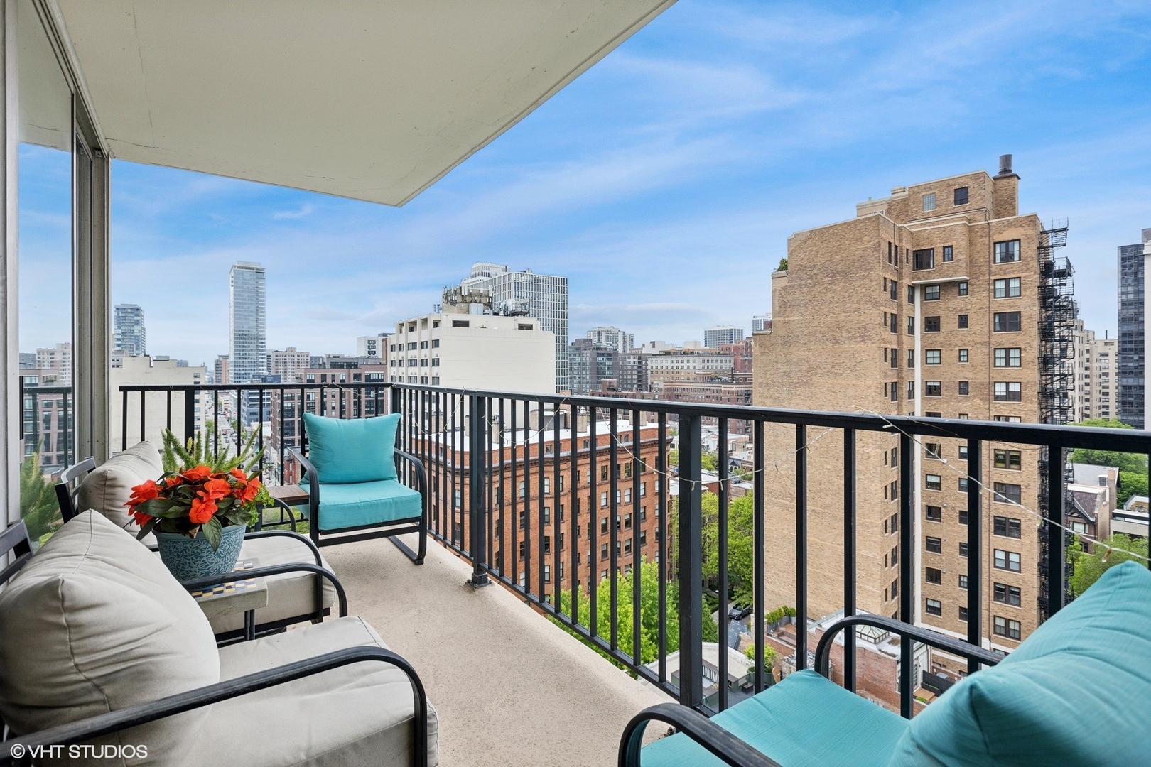 71 East Division Street, Unit 1606 Chicago, IL 60611 - Photo 8 of 34 a balcony with couple of flower plants and wooden fence