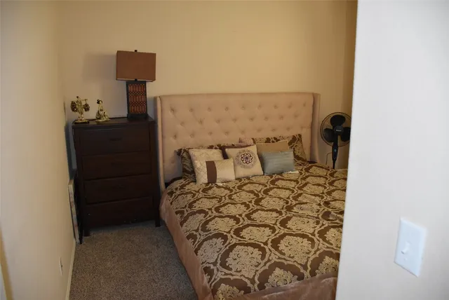 a bed room with a bed and a night stand