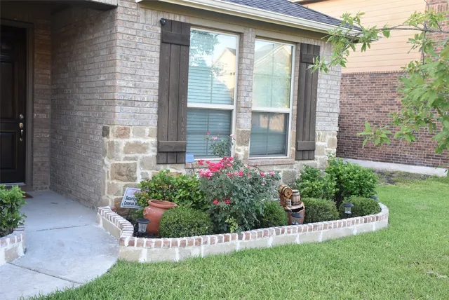 a view of a house with a yard and garden