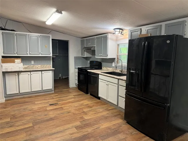 a kitchen with a refrigerator sink and stove