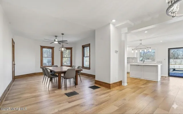 a view of a dining room with furniture and chandelier