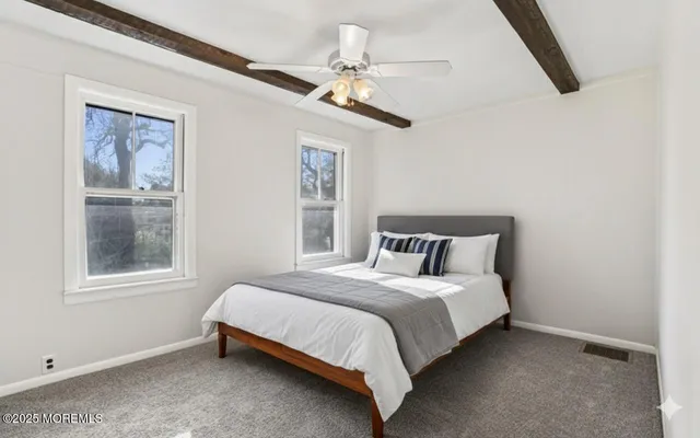 a bedroom with a large bed and a window