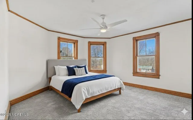 a bedroom with a bed lamp and window