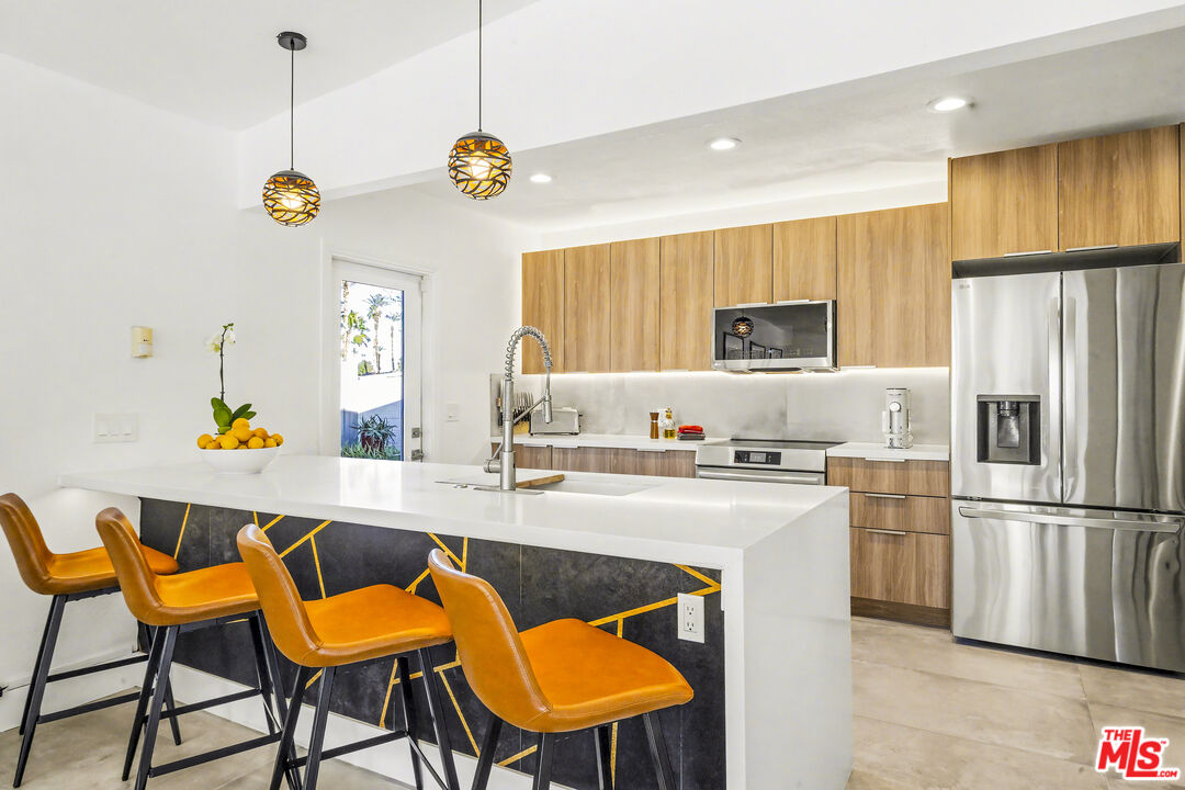 37223 Ferber Drive Rancho Mirage, CA 92270 - Photo 16 of 48 a kitchen with stainless steel appliances granite countertop a sink refrigerator and microwave
