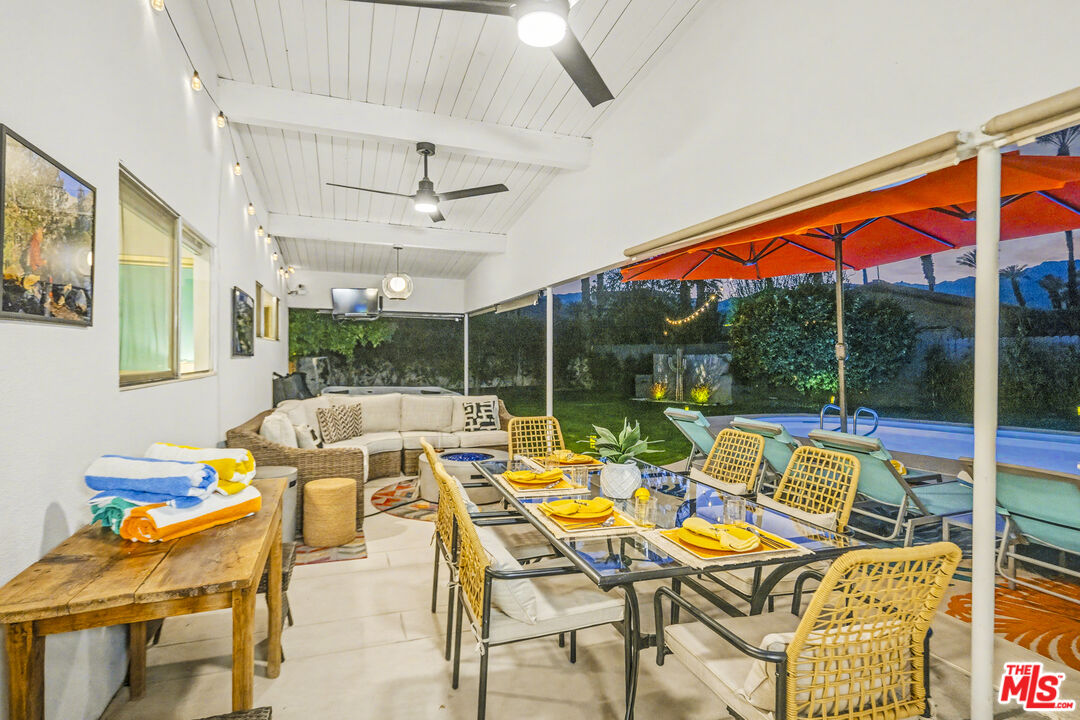 37223 Ferber Drive Rancho Mirage, CA 92270 - Photo 38 of 48 a living room with patio furniture and a floor to ceiling window