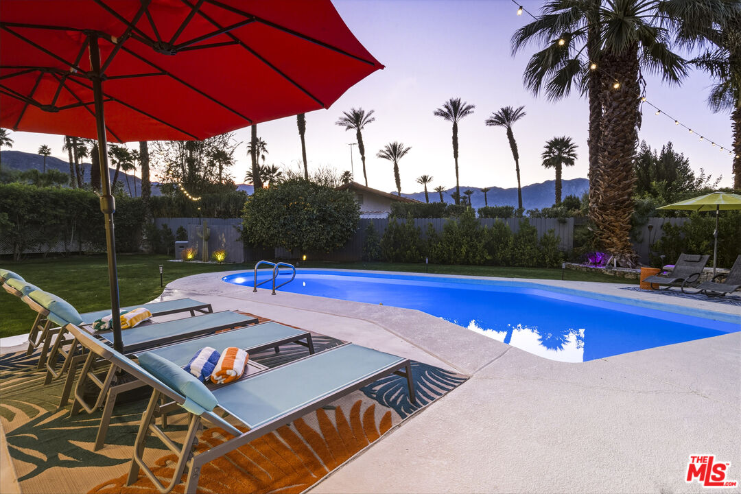 37223 Ferber Drive Rancho Mirage, CA 92270 - Photo 40 of 48 a view of swimming pool with a table and chairs under an umbrella