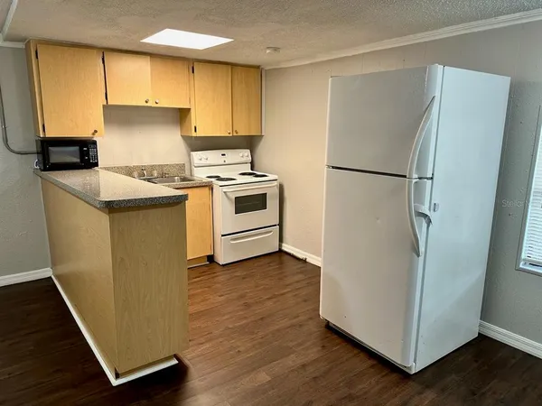 a kitchen with a refrigerator sink and stove