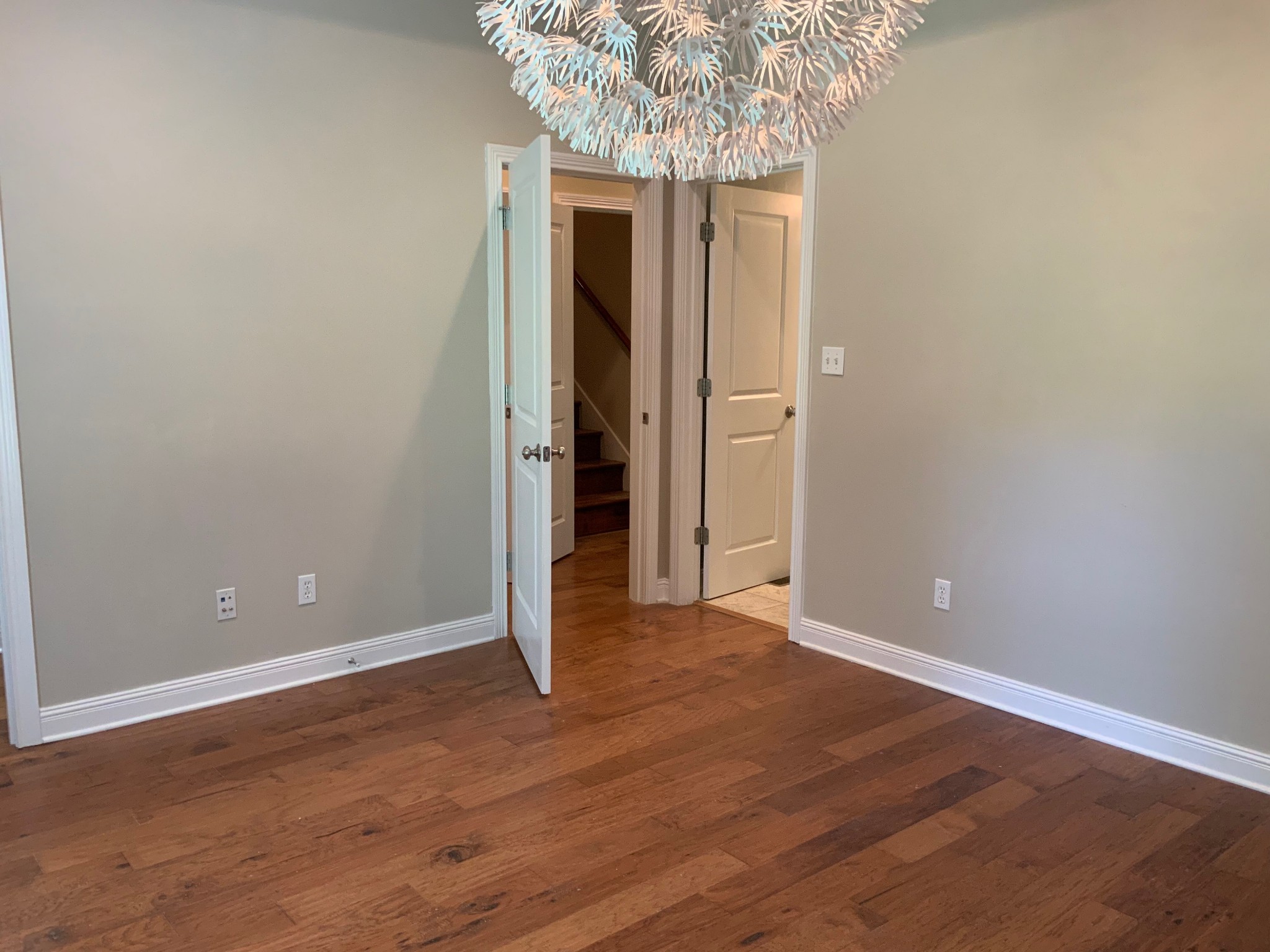 470 Clarks Store Sinking Fork Road Cerulean, KY 42215 - Photo 38 of 42 an empty room with wooden floor and chandelier