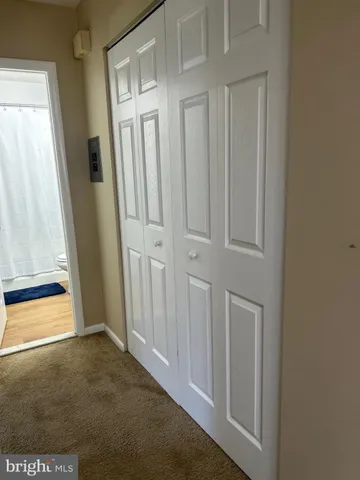 a bathroom with a toilet and a shower curtain