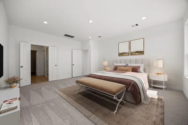a bedroom with furniture and a large window