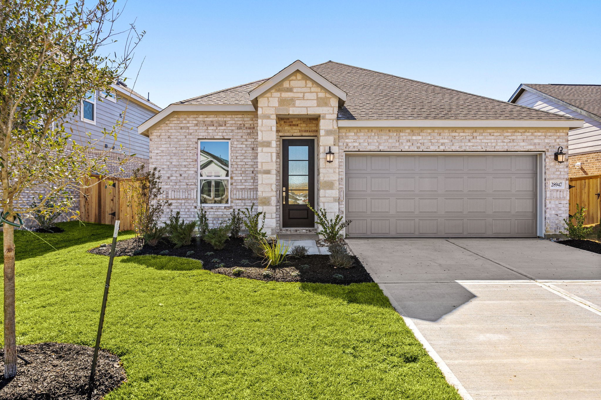 28947 Rustic Robin Lane Hockley, TX 77447 - Photo 3 of 33 Open the stunning wood, glass-inlayed front door that sets the contemporary vibe of this 4 bedroom home.