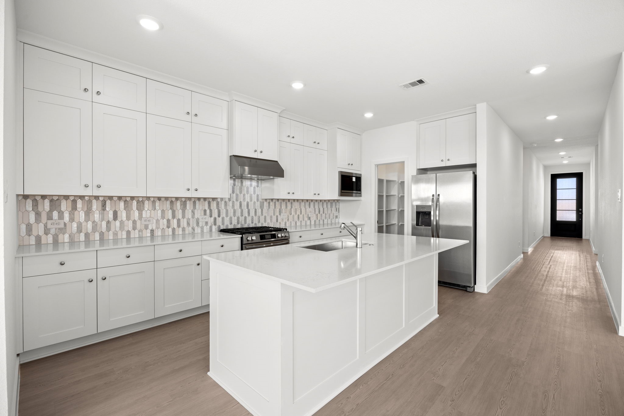 28947 Rustic Robin Lane Hockley, TX 77447 - Photo 4 of 33 The kitchen is luxuriously finished with beautiful quartz countertops and upper cabinets that go all the way to the ceiling! Storage galore!
