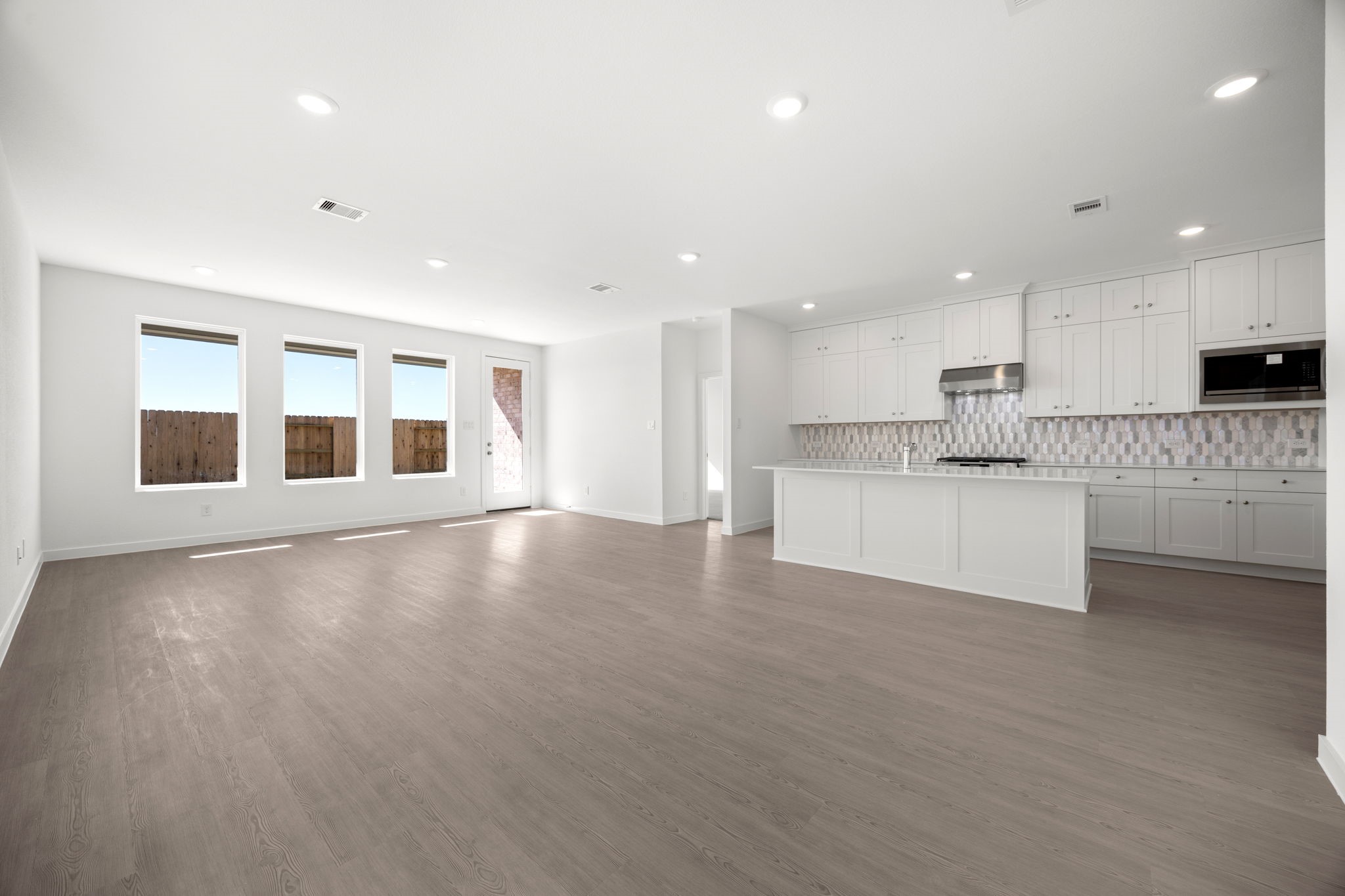 28947 Rustic Robin Lane Hockley, TX 77447 - Photo 33 of 33 Spacious open floor-plan with recessed lighting and mid-tone luxury vinyl plank flooring.