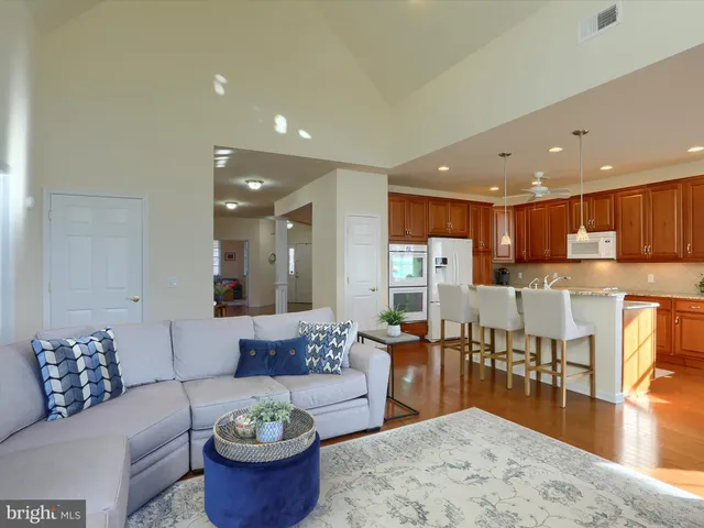 a living room with furniture and a view of kitchen
