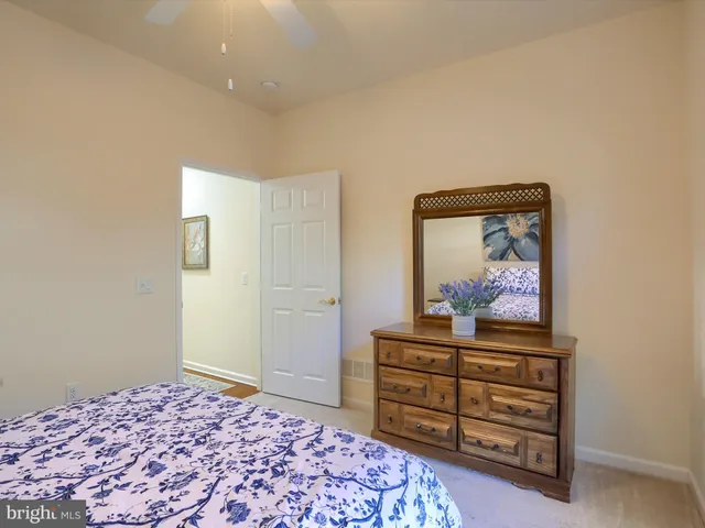 a bedroom with a bed and a dresser in it