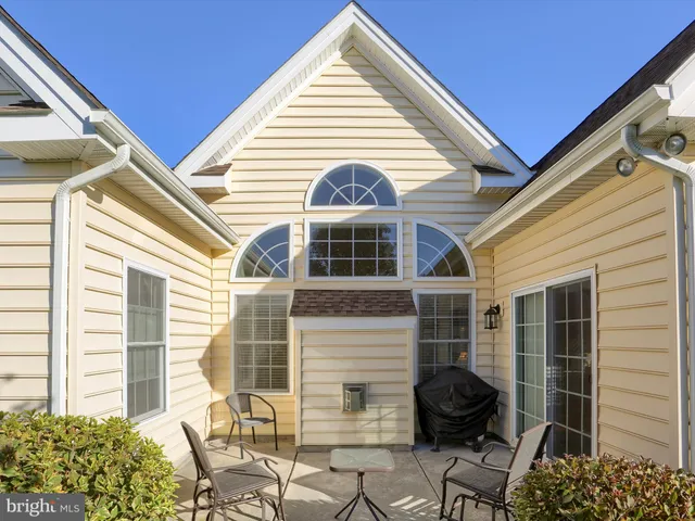 a view of a two chairs and table in the back