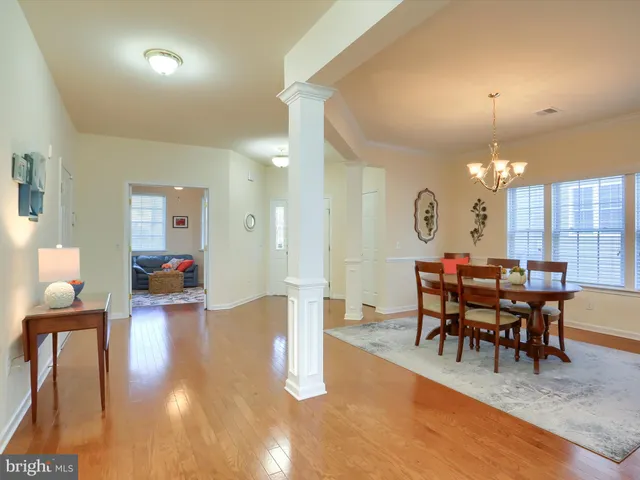 a view of a dining room with furniture and chandelier