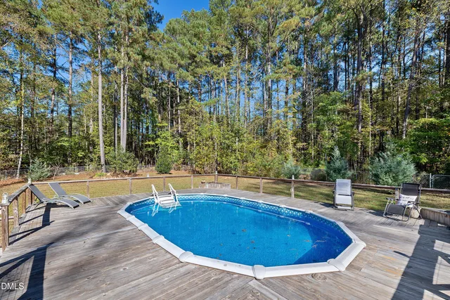 a swimming pool with outdoor seating and yard