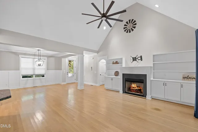 a view of an empty room with a fireplace and a window