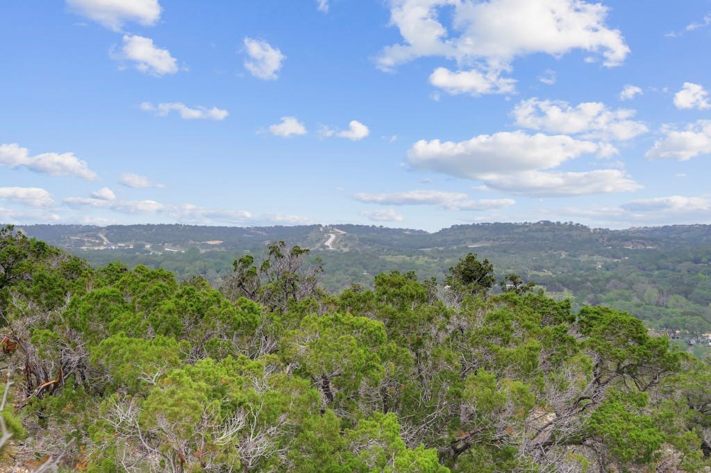 107 Sumac Ridge, Unit 159 Kendalia, TX 78027 - Photo 11 of 30 a view of a city with lush green forest