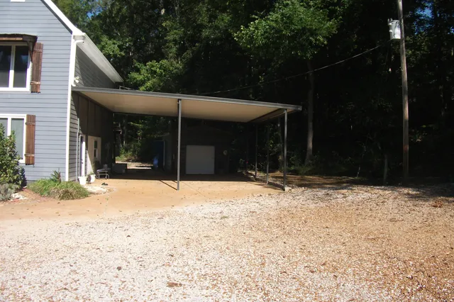 a view of a house with backyard outdoor space and porch